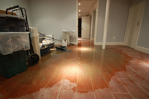 floor damaged caused by competing plumber's poor response time